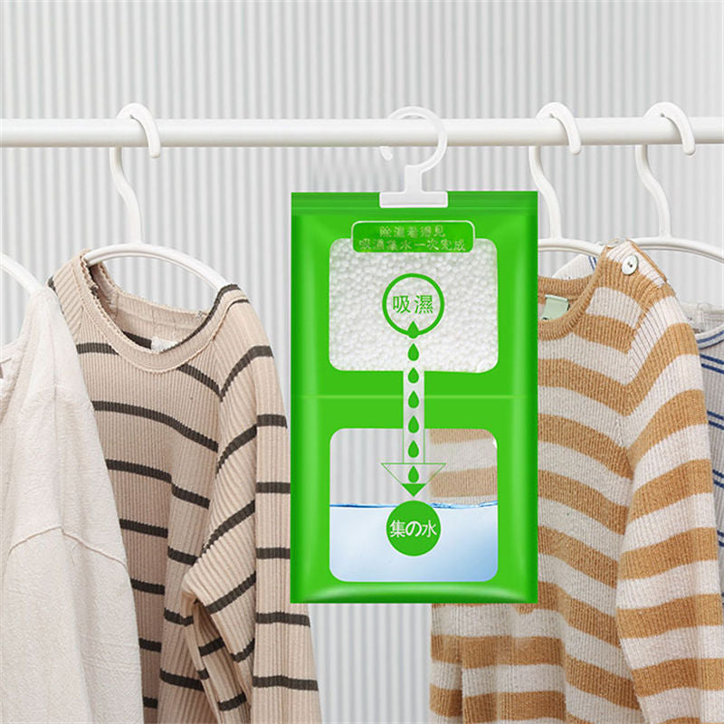 Green dehumidifier packet hanging on a clothes rack with clothes in the background