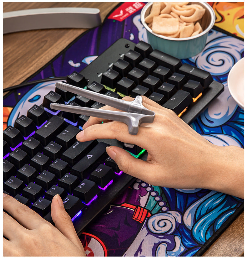 Person using a mechanical keyboard with a unique key attachment on a colorful mouse pad.