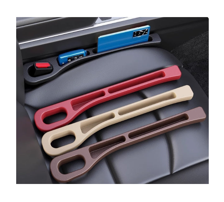 Set of three car seat organizers in red, beige, and brown on a car seat.